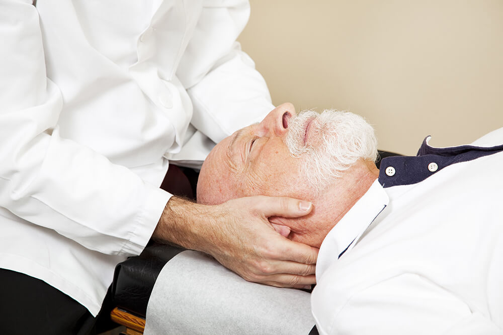 Man getting a chiropractic adjustment on head and neck