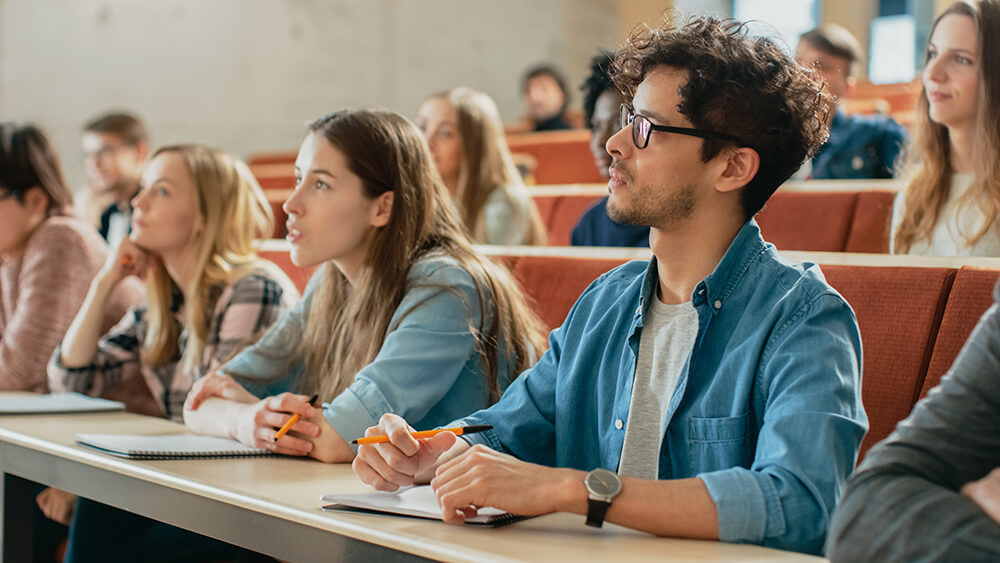 Students listening to lecture in class in college or university